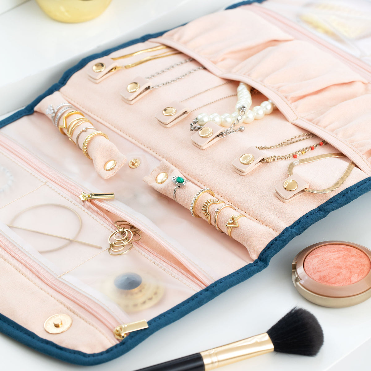 Blue Oabella organizer laid open with rings and necklaces