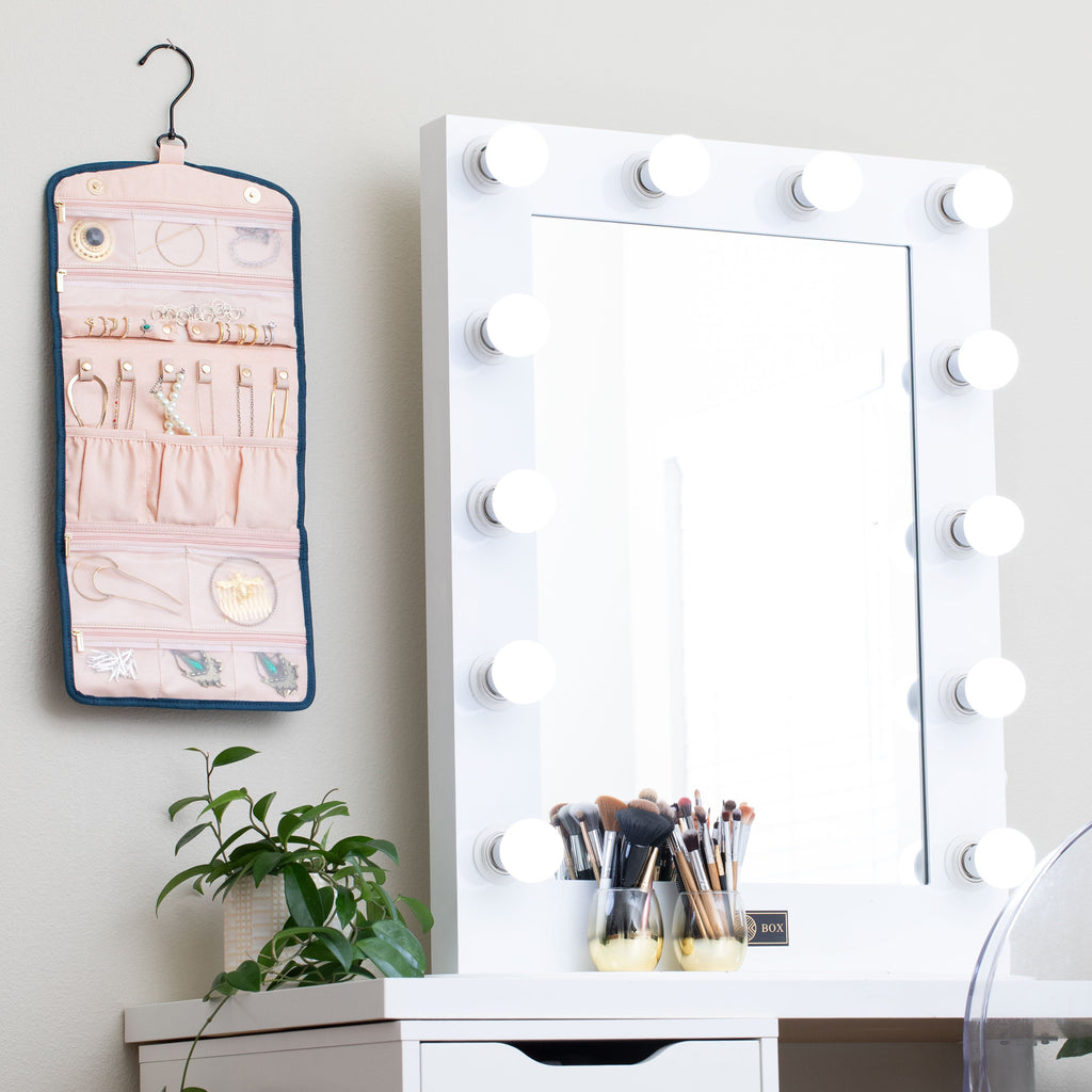 Oabella jewelry organizer hanging next to a vanity mirror